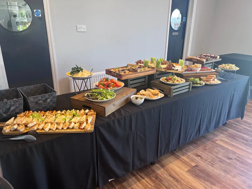 Buffet lunch laid out on a long table in the event room at Brampton Park Golf Club