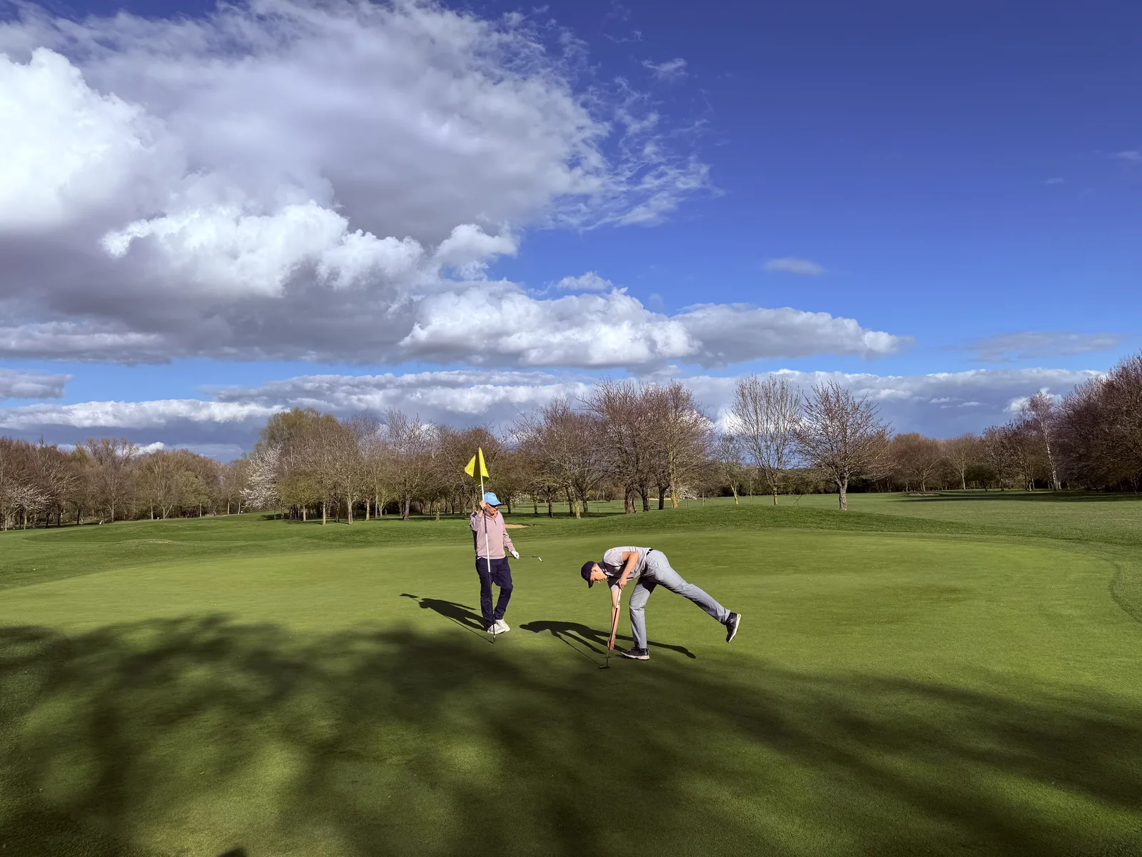 Brampton Park Golf Club 15 Golfers lining up a putt on a green at Brampton Park
