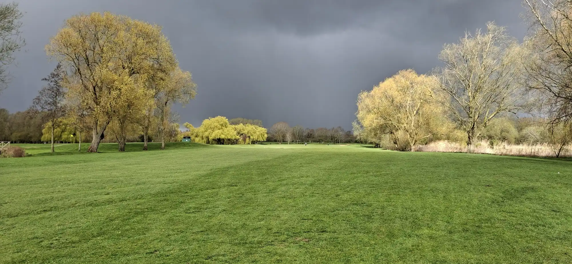 Brampton Park Golf Club 9 Storm clouds over a parkland fairway at Brampton Park Golf Club